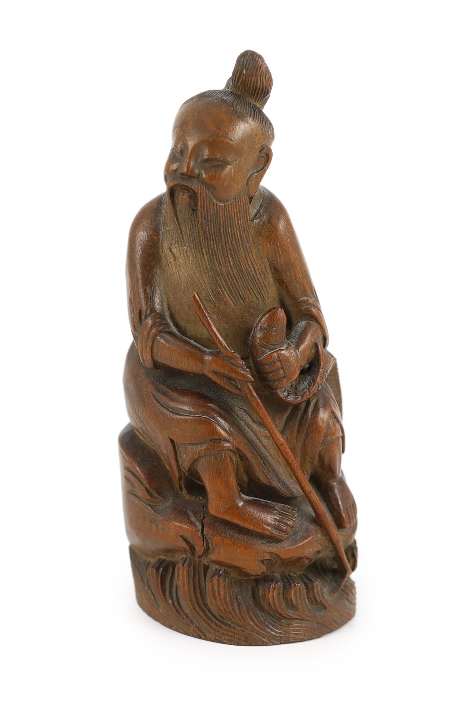 A Chinese bamboo figure of a seated fisherman, 19th century, 16.5 cm high